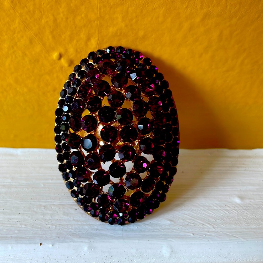 Vintage cocktail ring. This ring makes a bold statement. Purple gemstones.